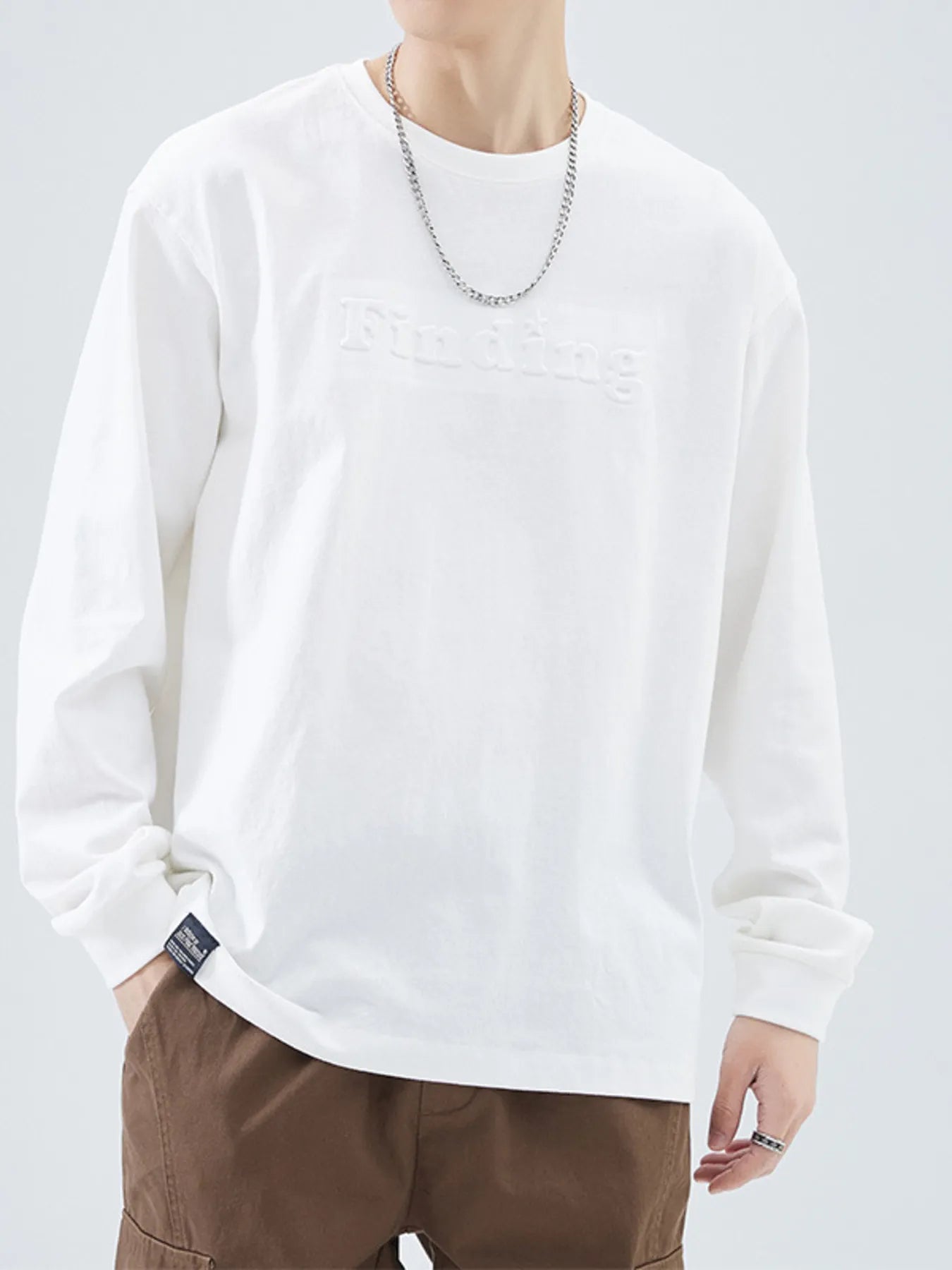 Close-up of embroidered detail on crewneck sweatshirt