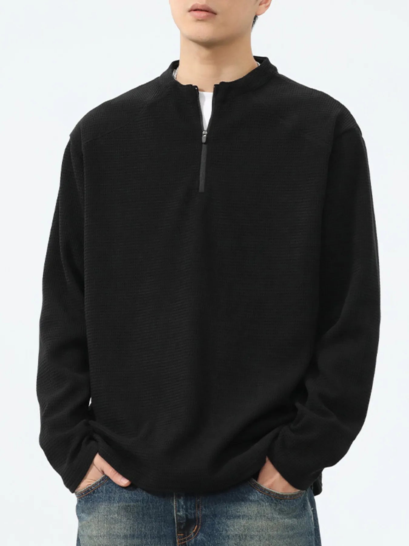 Close-up of waffle-knit texture and quarter-zip detail on T-shirt