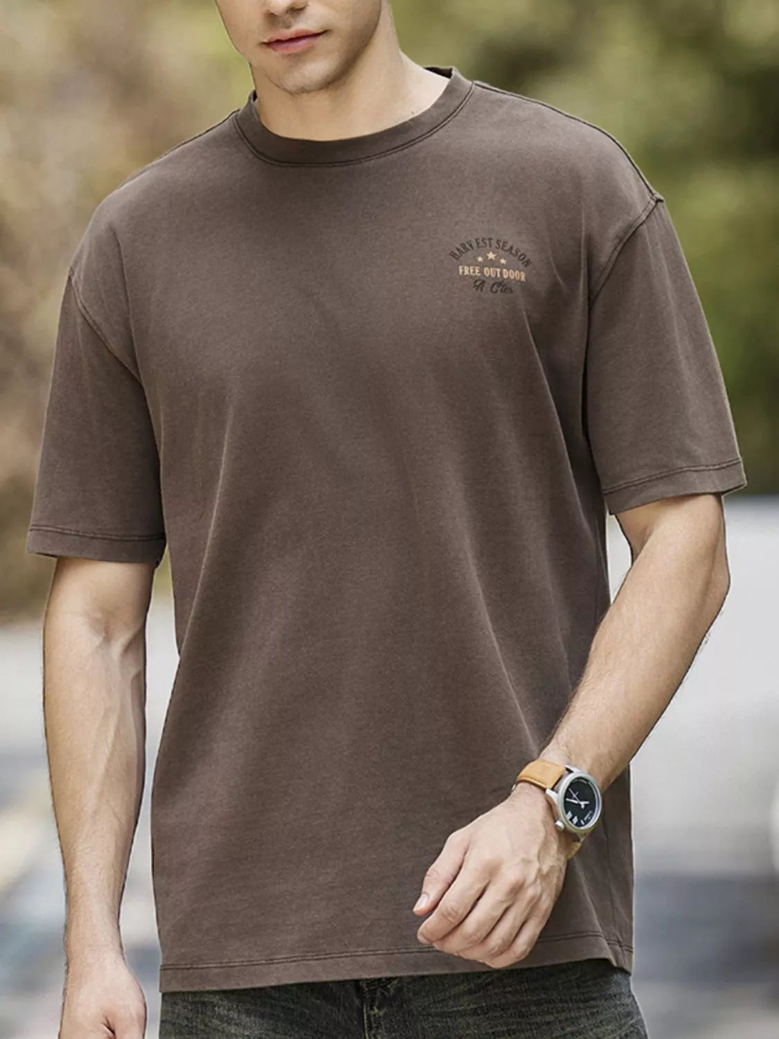 Close-up of washed fabric and graphic detail on round neck T-shirt