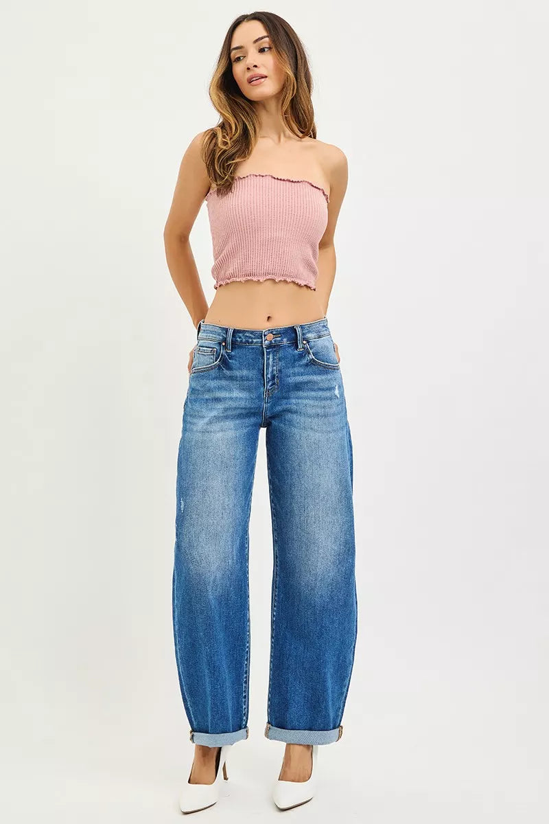 Plus size model wearing mid-rise barrel jeans styled with a cropped sweater