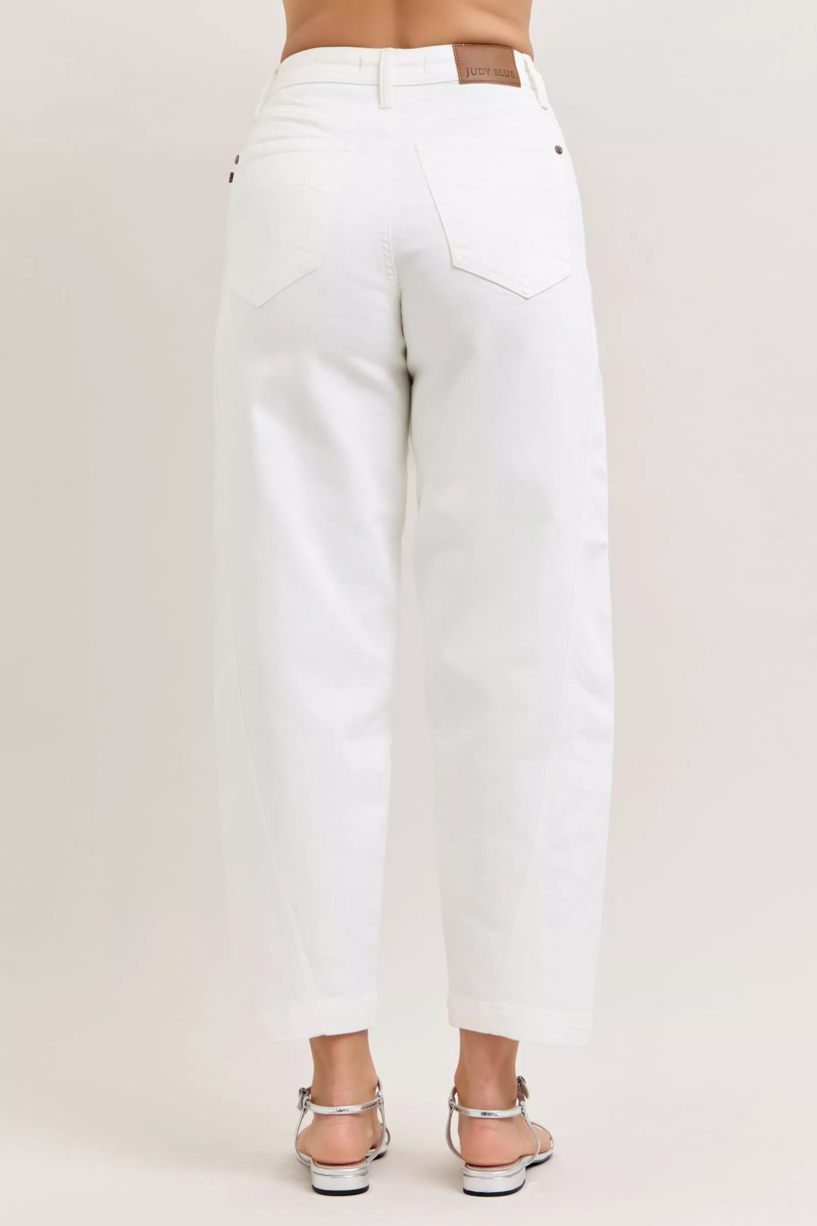 Model wearing high-waisted barrel leg jeans styled casually