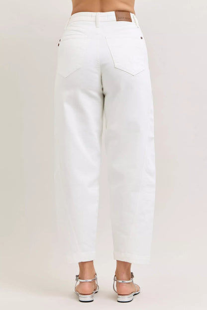 Model wearing high-waisted barrel leg jeans styled casually