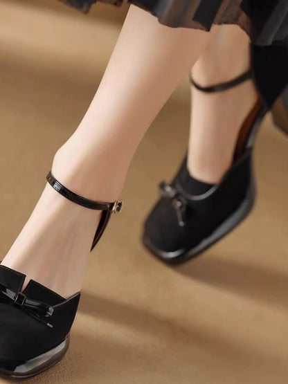 Model wearing bow ankle strap pumps styled for an upscale evening event