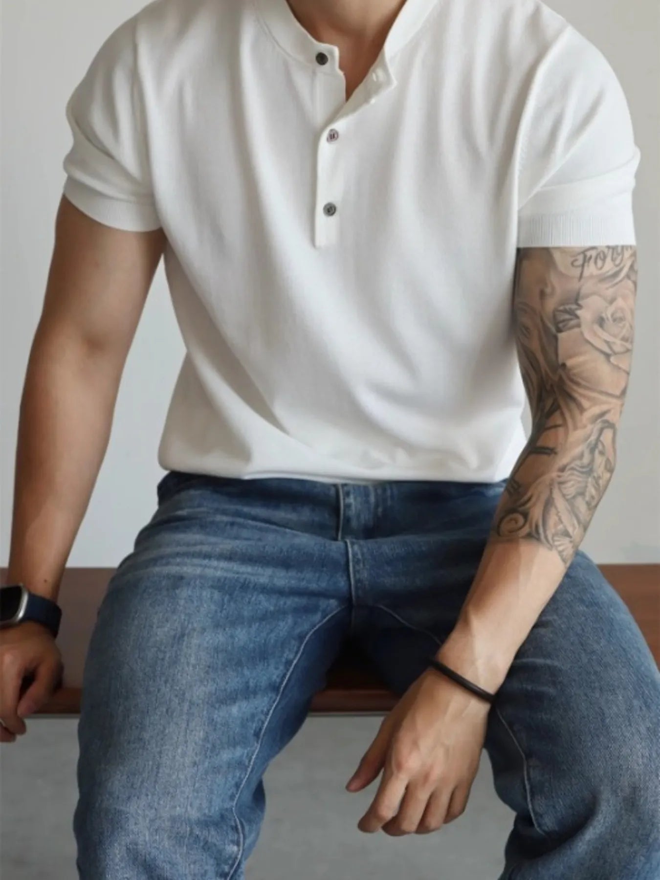 Model wearing minimal button accent short sleeve T-shirt styled casually