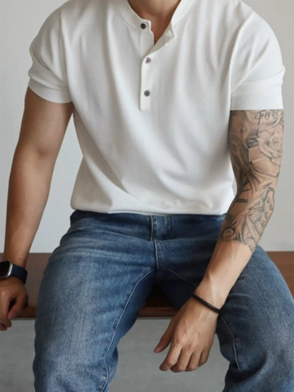 Model wearing minimal button accent short sleeve T-shirt styled casually