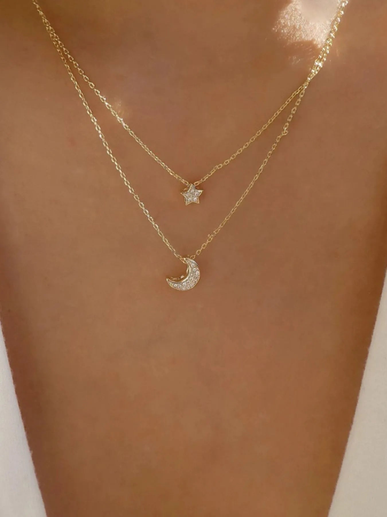 Front view of the 18K gold-plated double layered star and moon necklace
