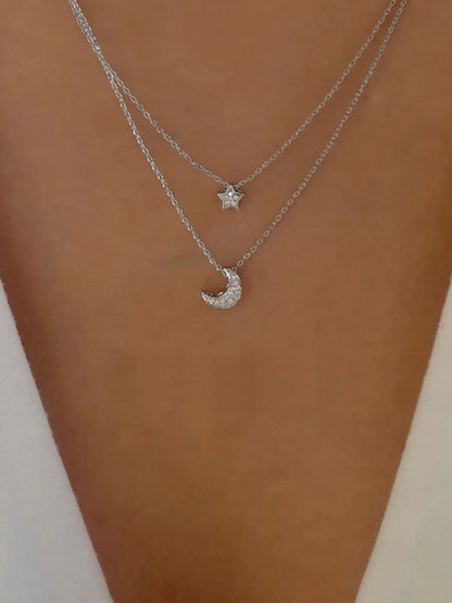 Model wearing the layered celestial necklace styled for a sophisticated evening event