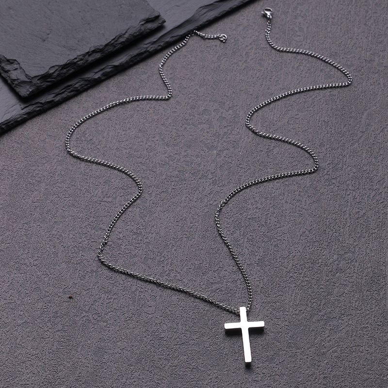Close-up of the robust box chain and the luminous polished surface of the cross pendant