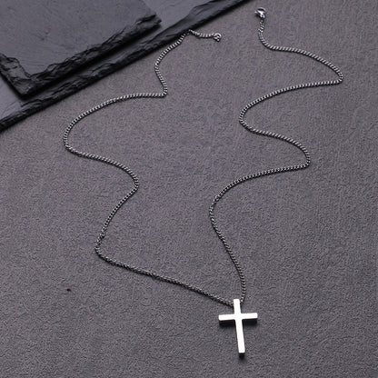 Close-up of the robust box chain and the luminous polished surface of the cross pendant