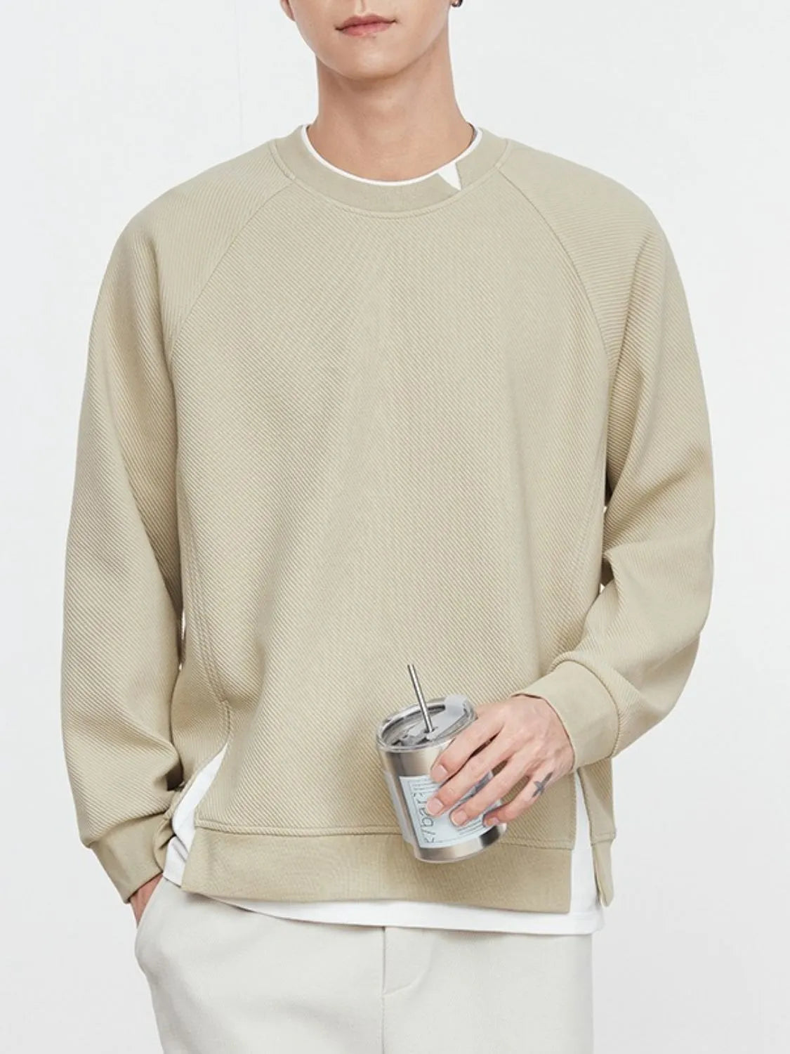 Model wearing contrast crew neck sweatshirt styled casually