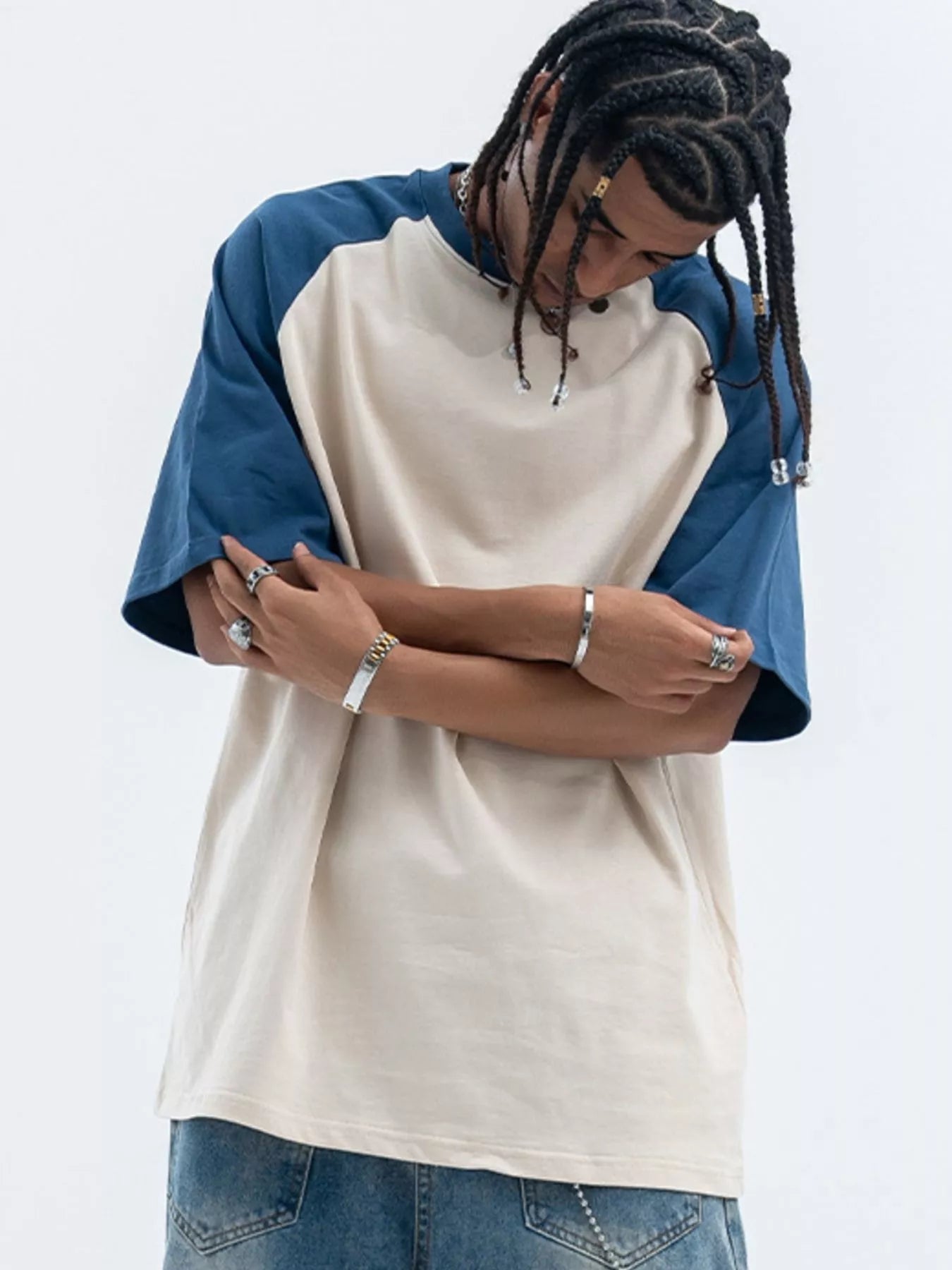 Model wearing contrast stitch round neck half sleeve T-shirt styled casually