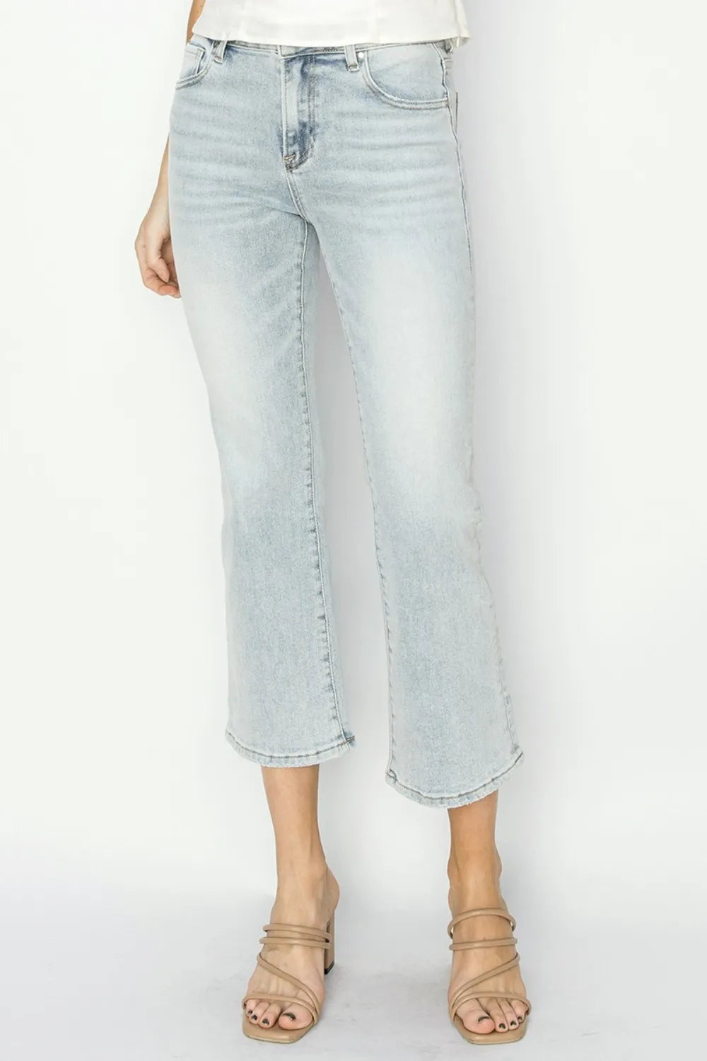 Front view of Risen mid-rise cropped flare jeans with a washed finish