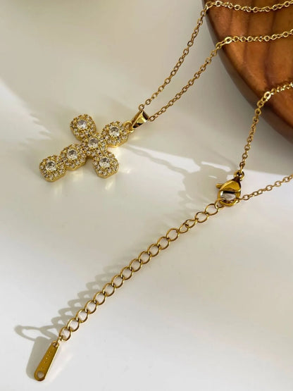 Model wearing the zircon cross necklace styled with a structured blazer