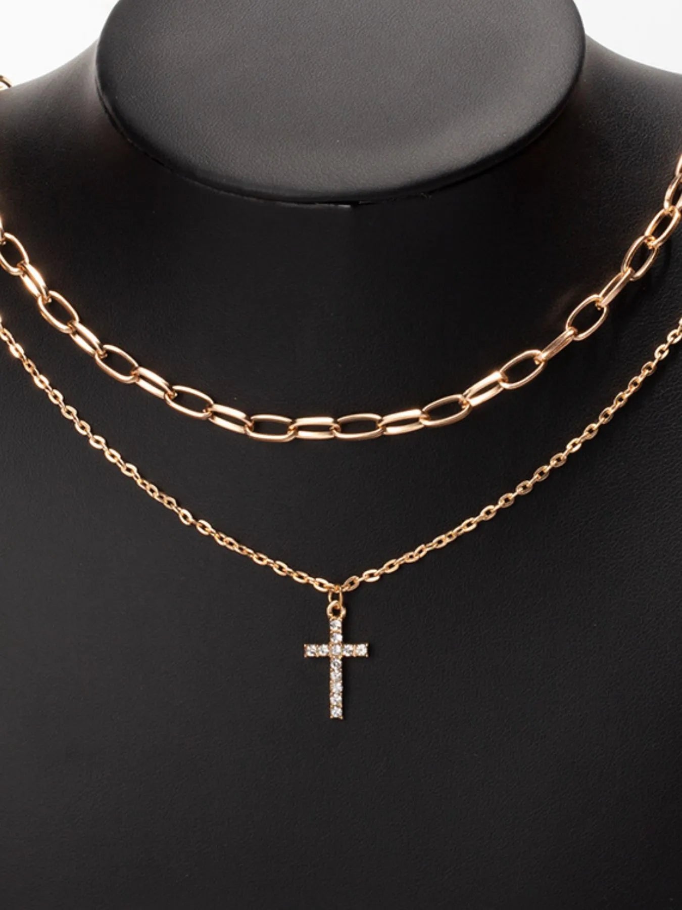 Model wearing the double-layered zircon cross necklace styled for an upscale evening event