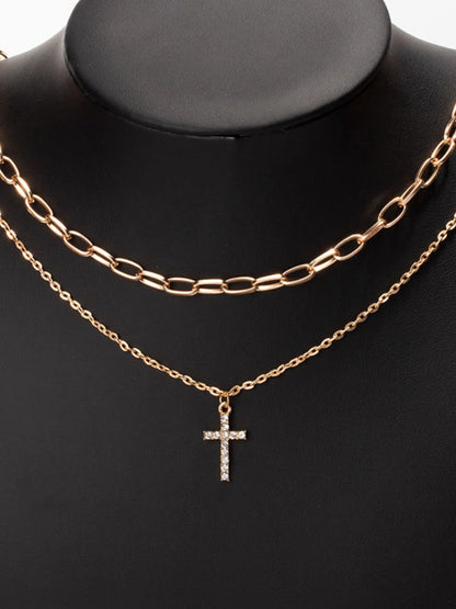 Model wearing the double-layered zircon cross necklace styled for an upscale evening event