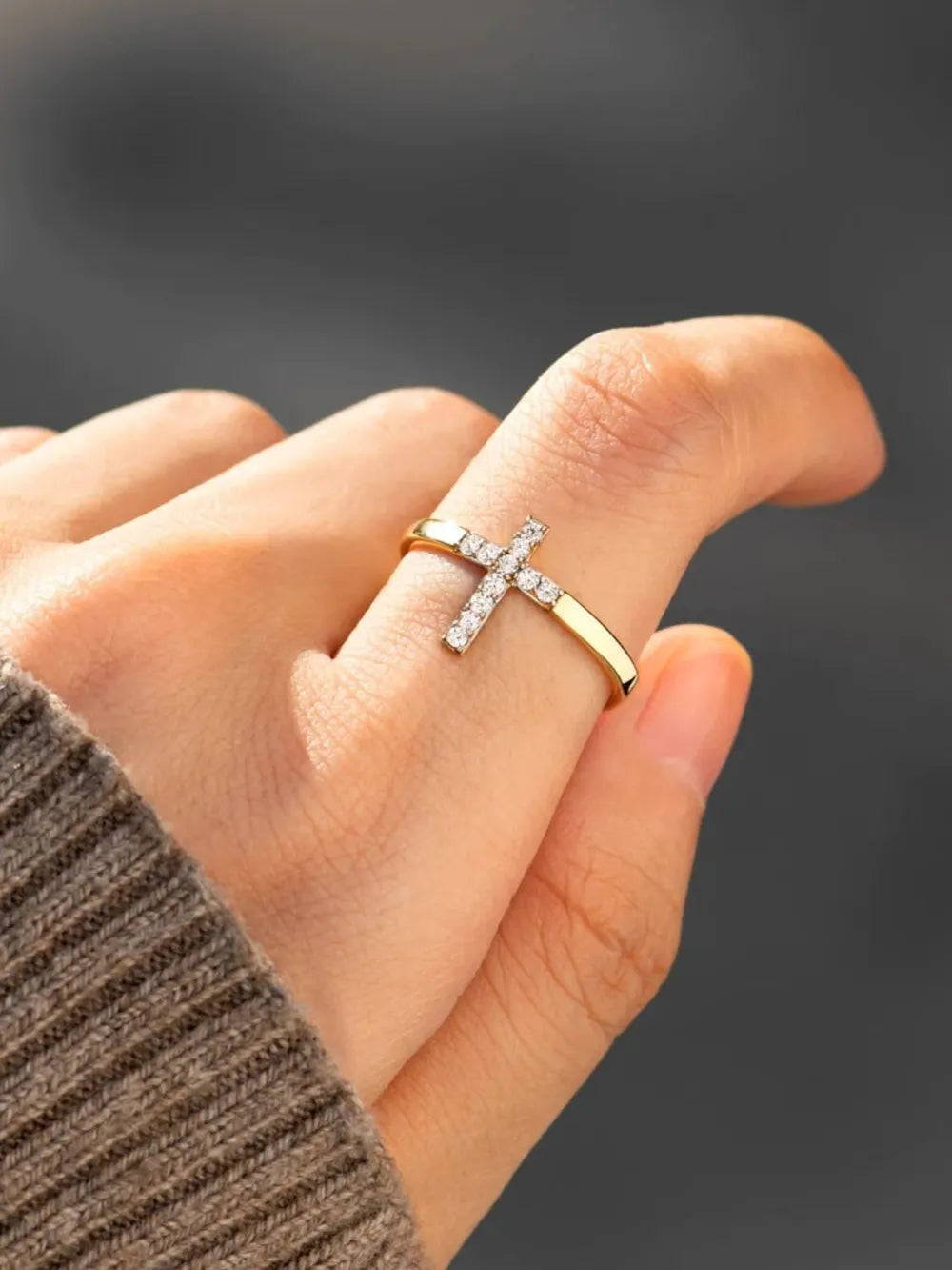 Model wearing the zircon cross ring styled with a structured blazer
