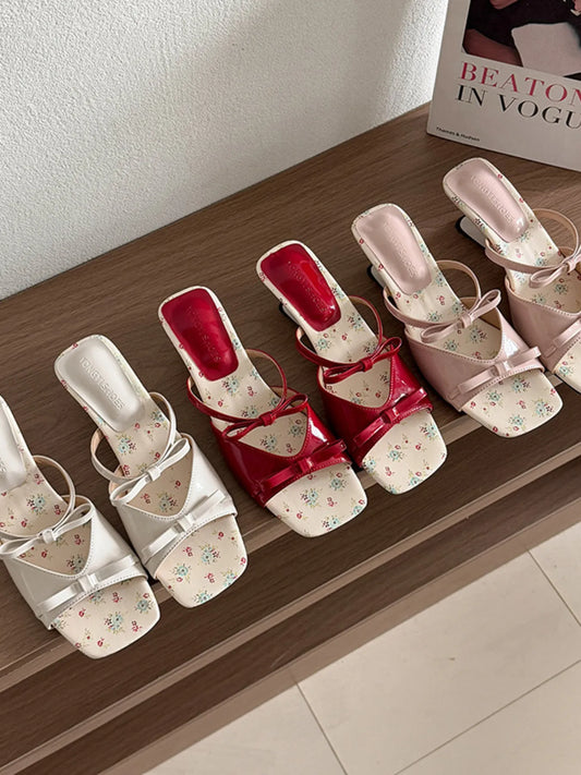 Top view of the double bow patent sandals showcasing the dimensional bow detail