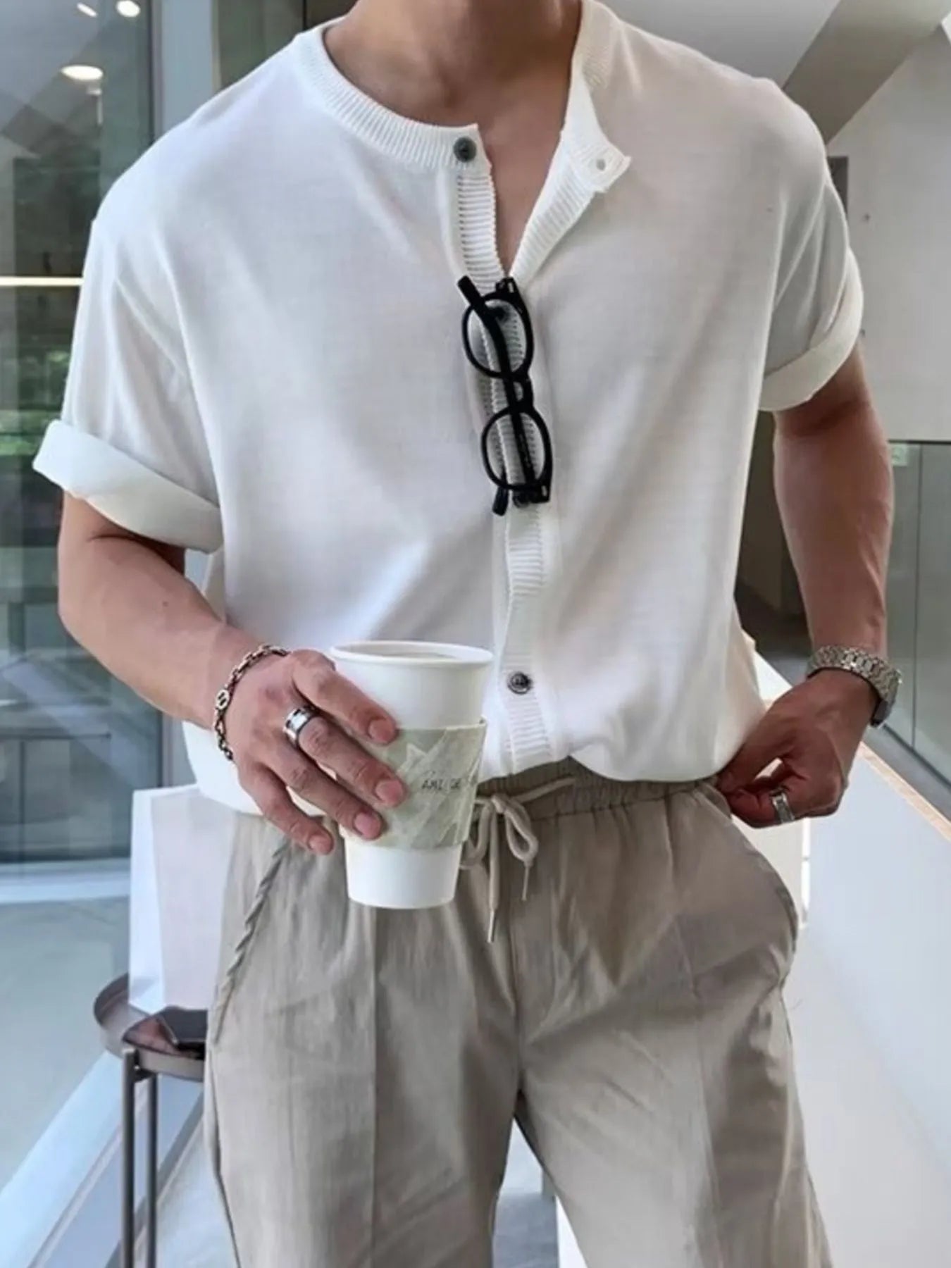 Front view of buttoned drawstring short sleeve top