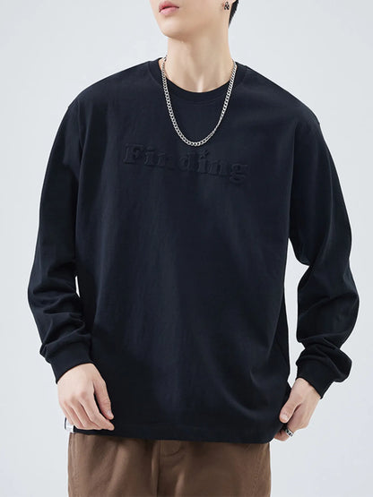 Model wearing oversized embroidered crewneck sweatshirt styled casually