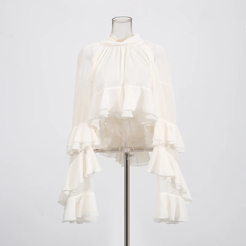 Back view of elegant sheer blouse with patchwork ruffles and high-neck design