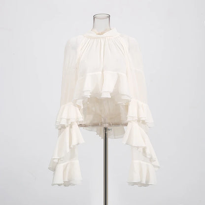 Back view of elegant sheer blouse with patchwork ruffles and high-neck design