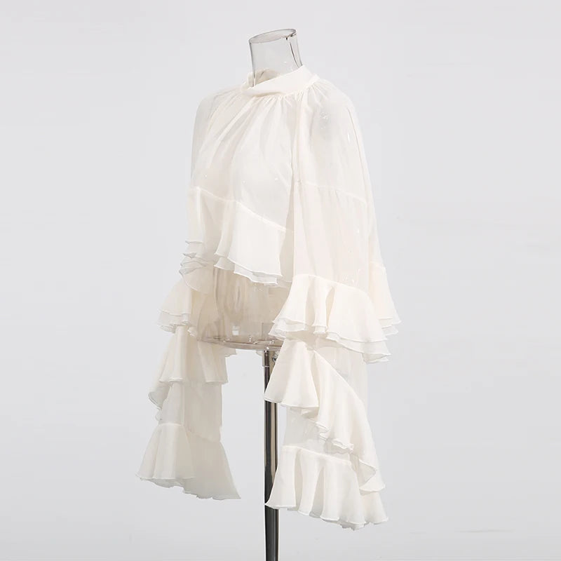 Side view showcasing tiered folds and long sleeves of luxury women’s blouse