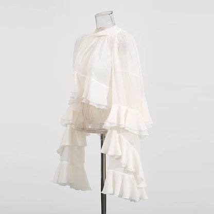 Side view showcasing tiered folds and long sleeves of luxury women’s blouse