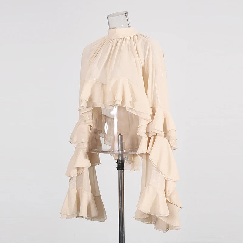 Detail of long sleeves and subtle stretch on luxury loose fit ruffled blouse