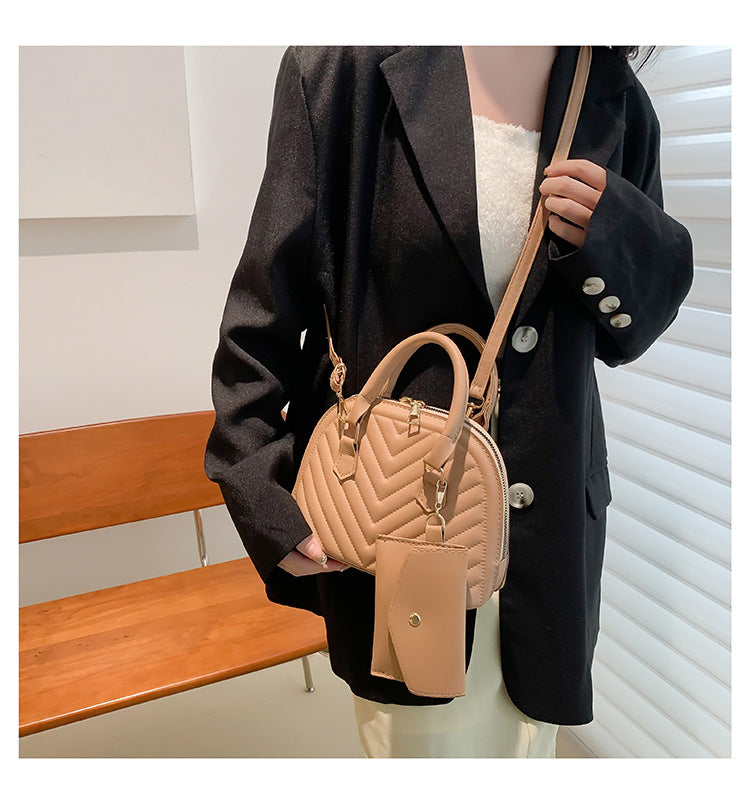Model carrying the minimalist commuter shell bag styled for a high-profile city transit