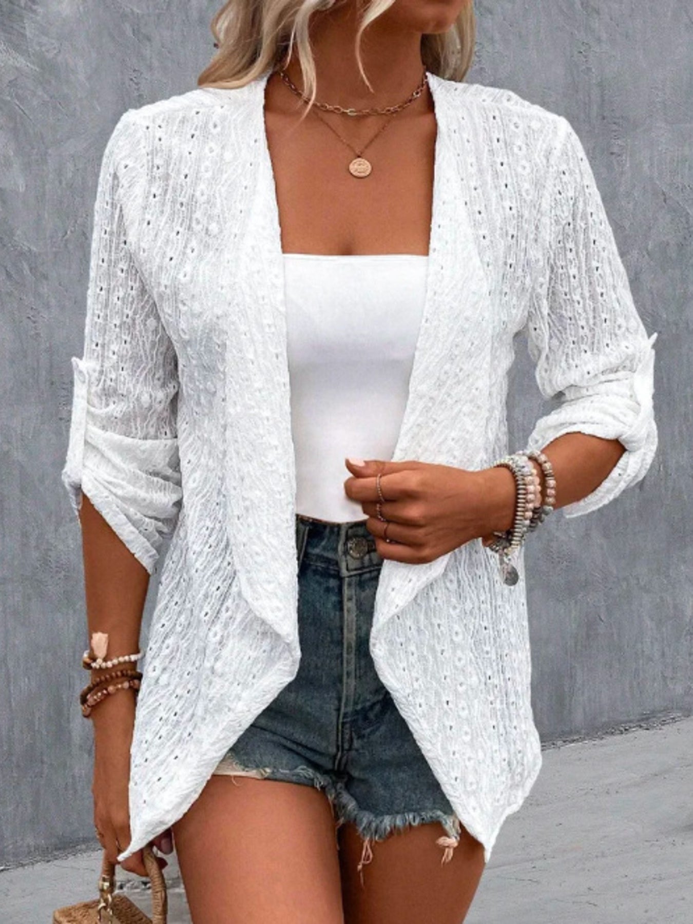 Close up of eyelet embroidery detail on elegant women open front cardigan