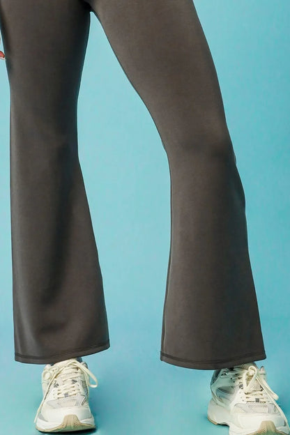 Model wearing black flare leggings styled for a modern athleisure look