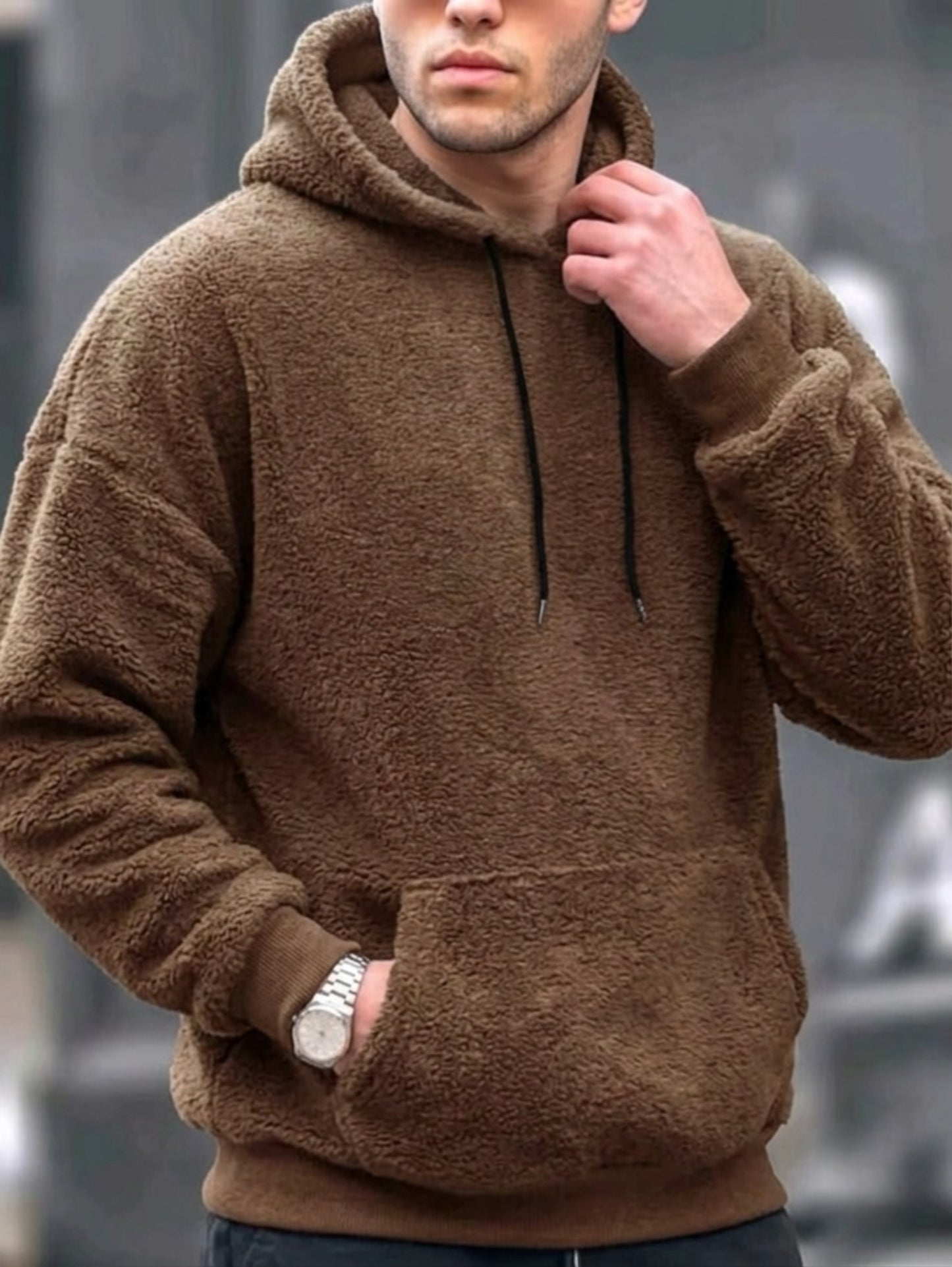 Model wearing drawstring fleece hoodie styled for casual look