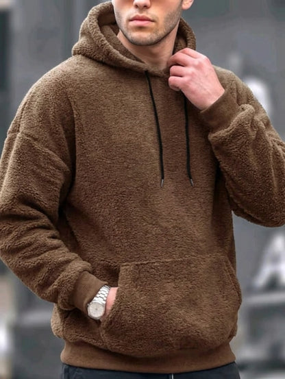 Model wearing drawstring fleece hoodie styled for casual look