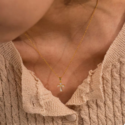 Woman wearing 18K gold plated zircon cross necklace styled elegantly