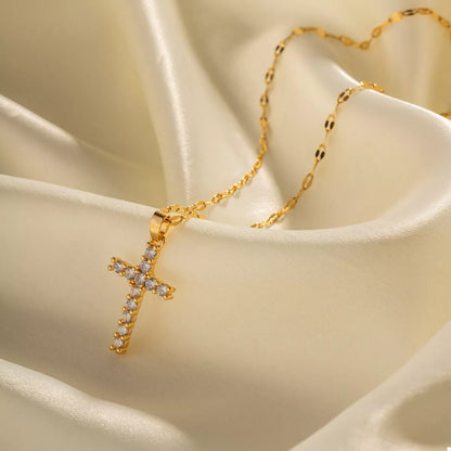 Woman wearing 18K gold plated cross pendant necklace styled elegantly