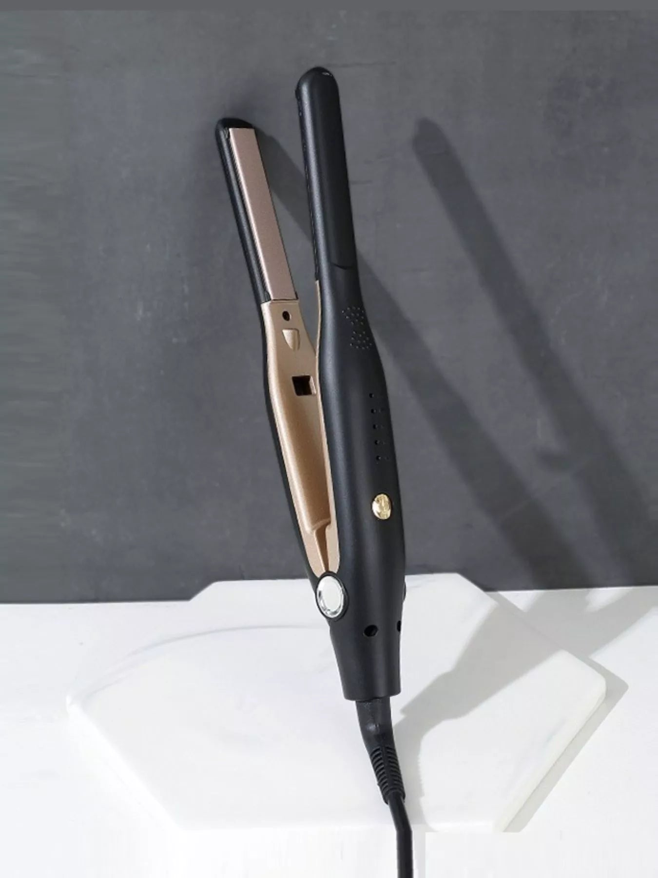 Close up of hair straightener showing temperature control