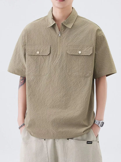 Close-up of half-zip closure and chest pocket on polo shirt