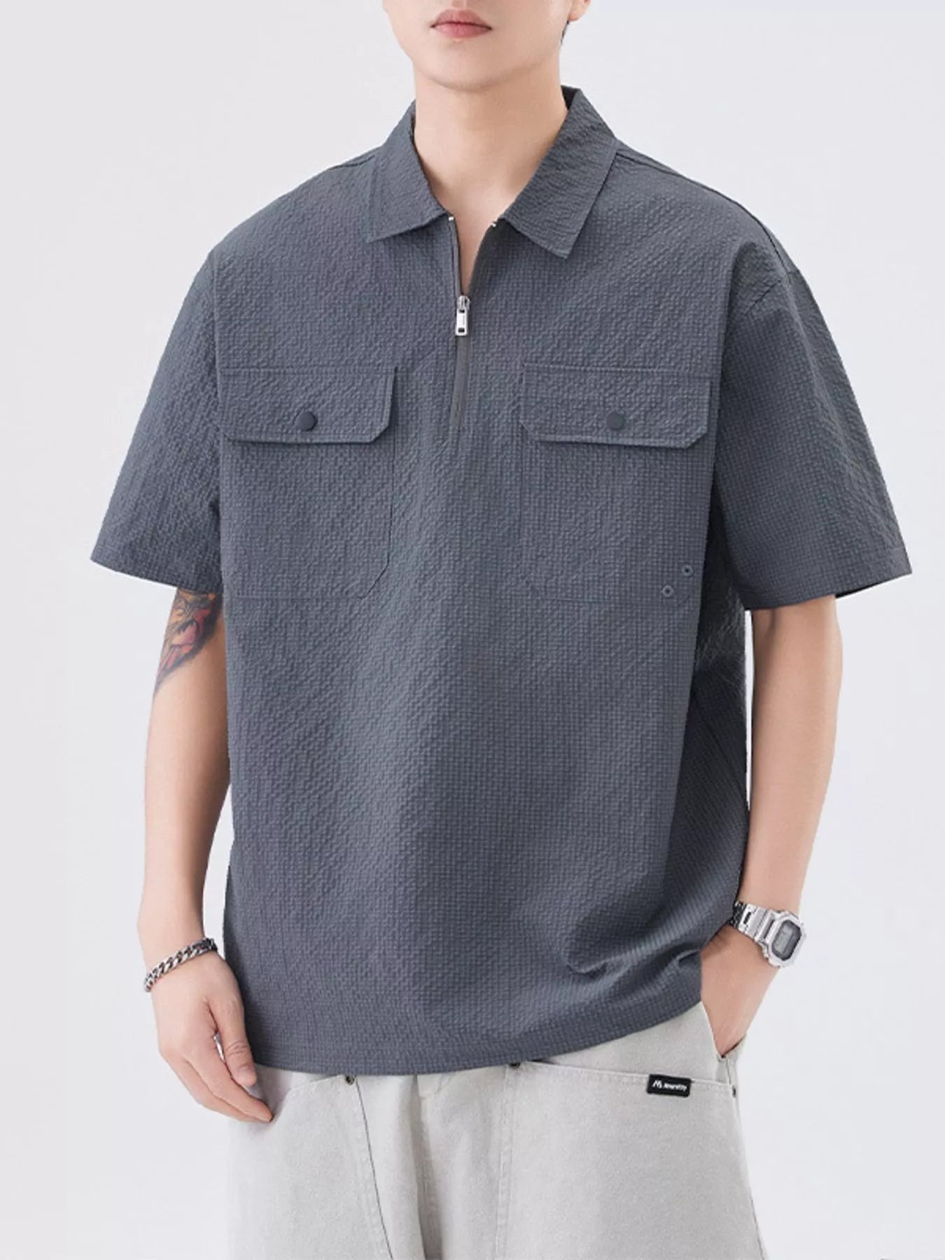 Model wearing modern half-zip pocket polo shirt styled casually