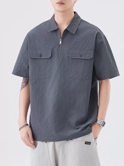 Model wearing modern half-zip pocket polo shirt styled casually