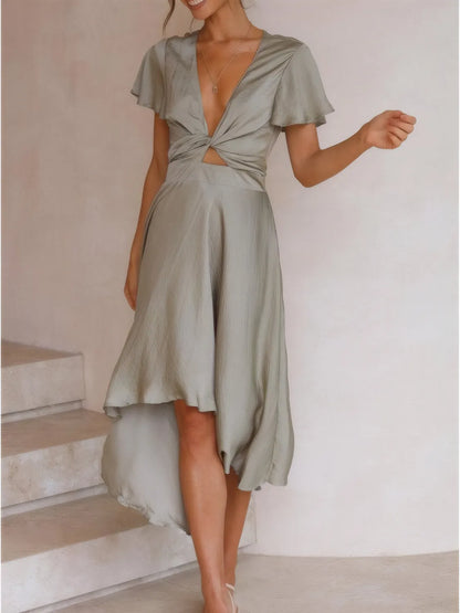 Woman wearing high-low plunge flutter sleeve dress styled elegantly