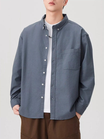 Model wearing men's plus size button up long sleeve shirt styled casually
