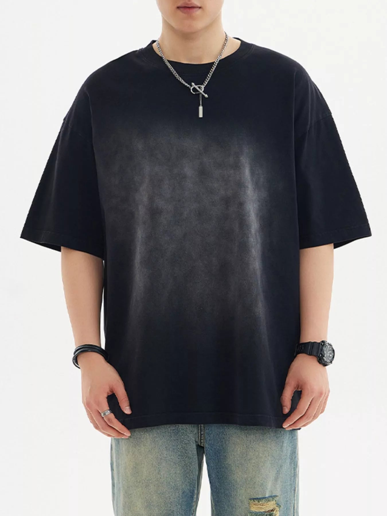 Model wearing oversized cotton half sleeve round neck T-shirt styled casually