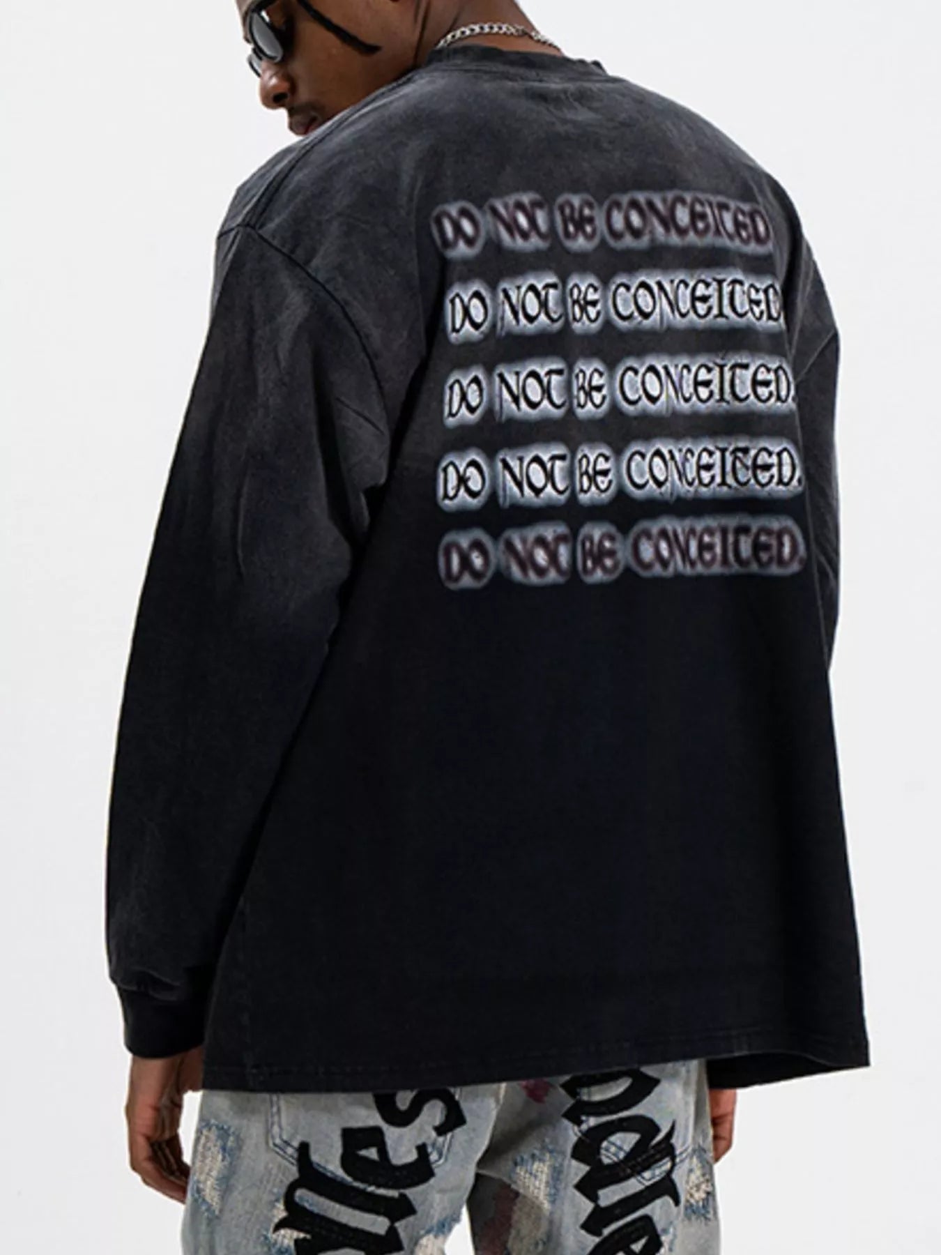 Close-up of letter graphic print on oversized long sleeve T-shirt