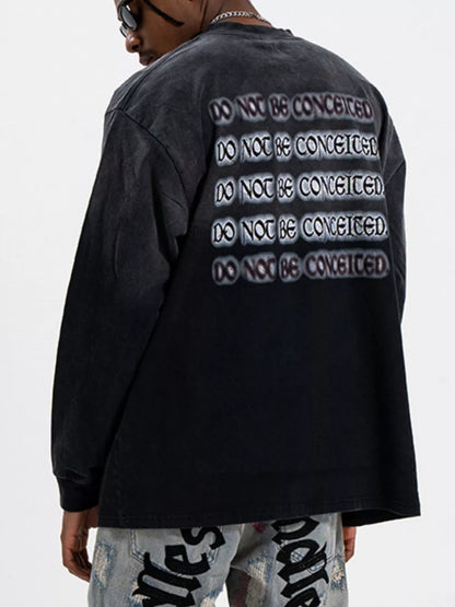Close-up of letter graphic print on oversized long sleeve T-shirt