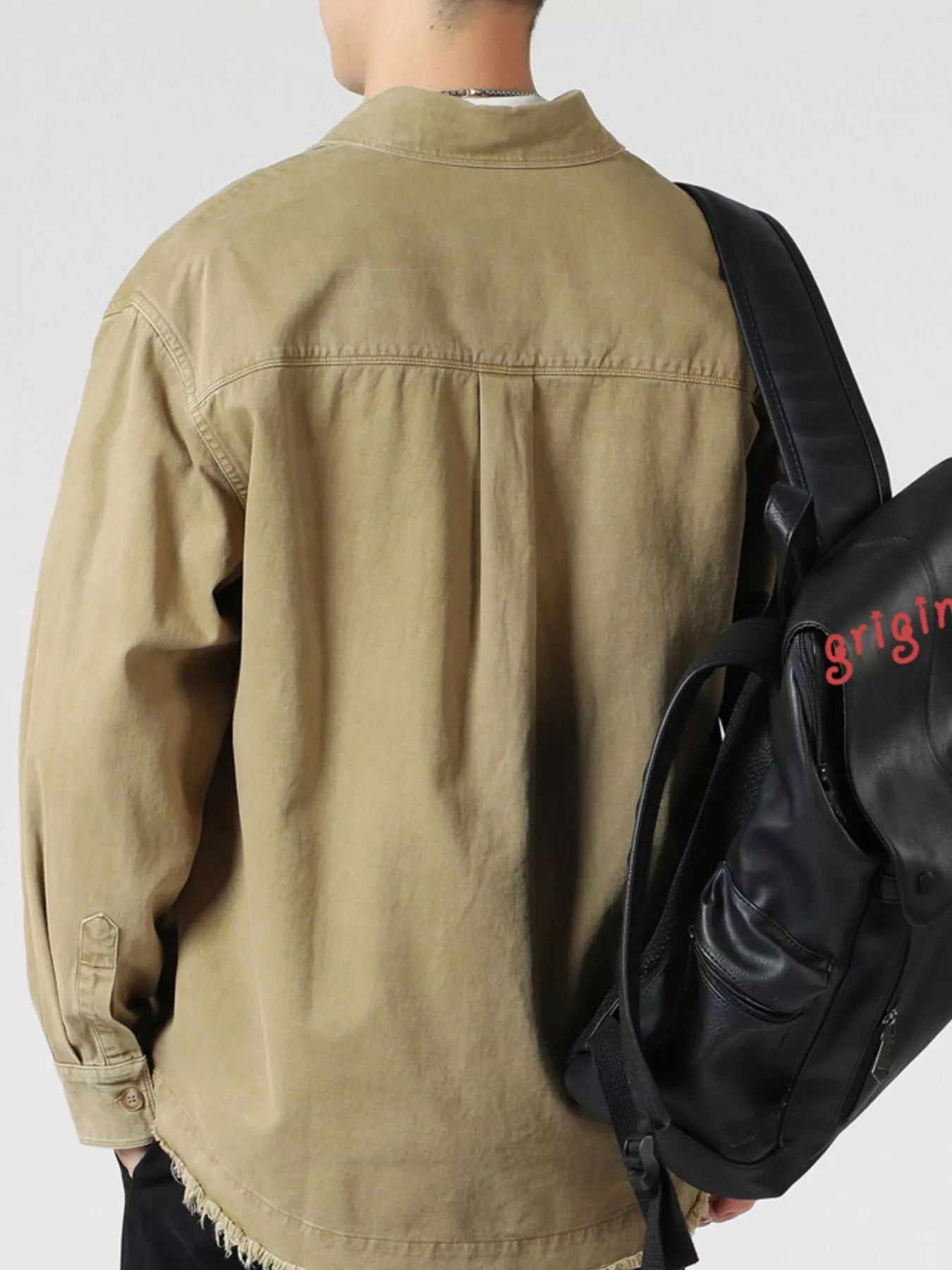 Close-up of fabric and button detail on oversized long sleeve shirt