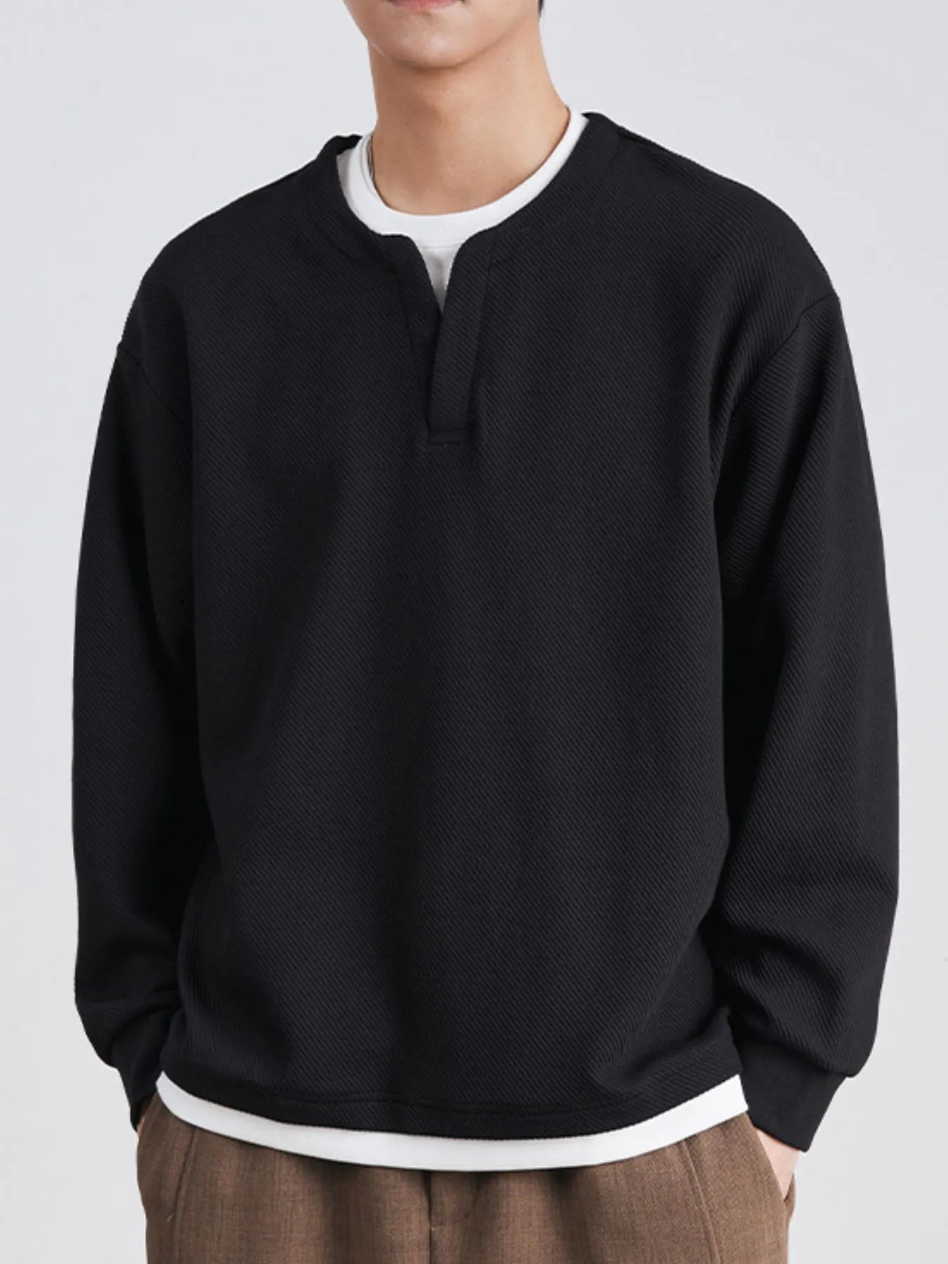 Model wearing oversized round neck sweatshirt styled casually