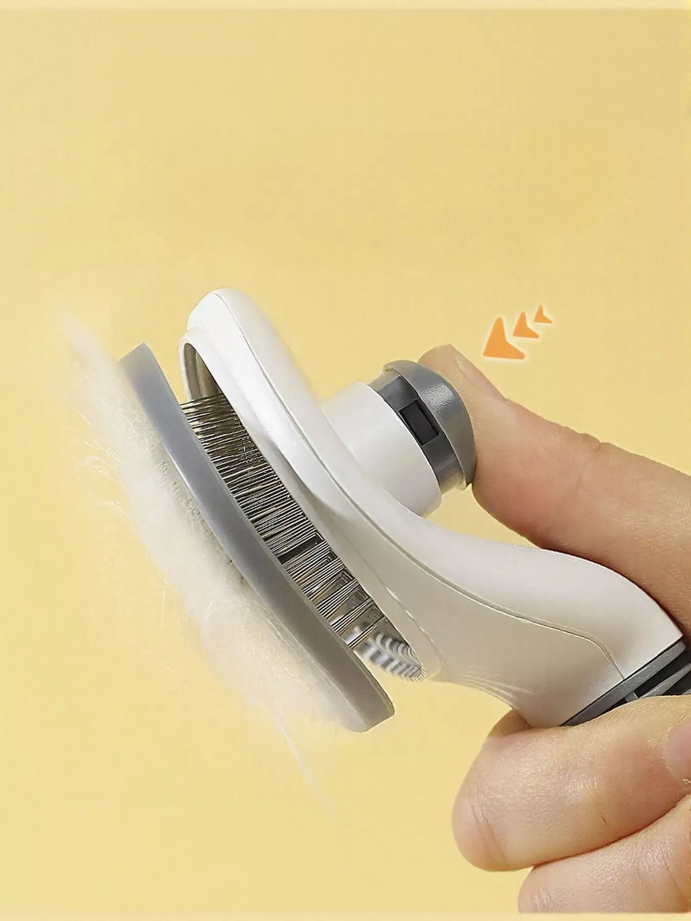 Pet being groomed with self-cleaning slicker brush
