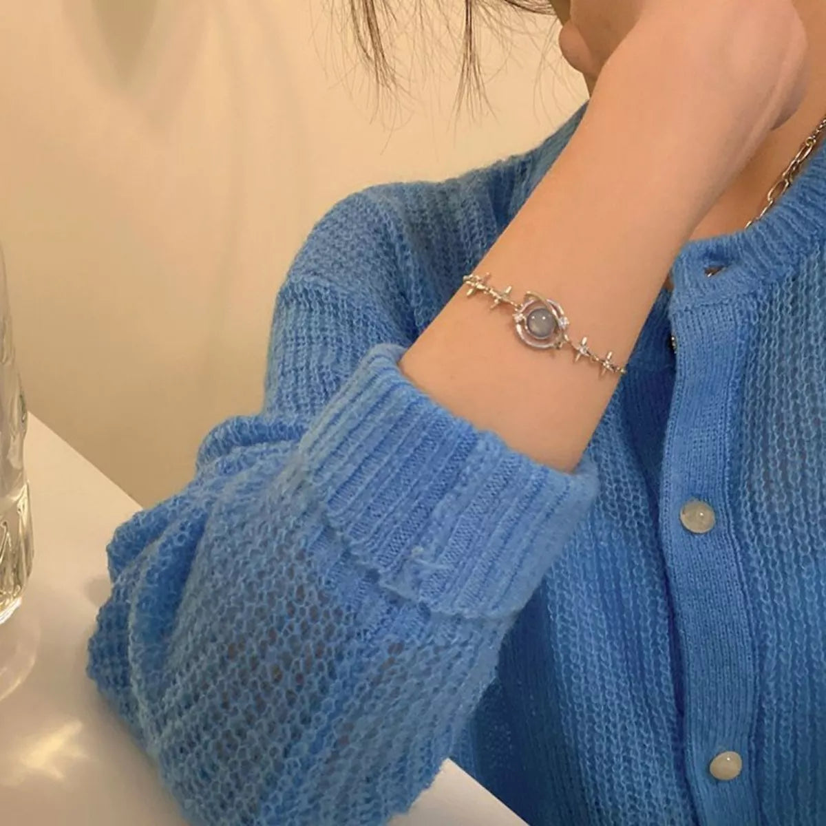 Model wearing the silver planet bracelet styled for a curated weekend look