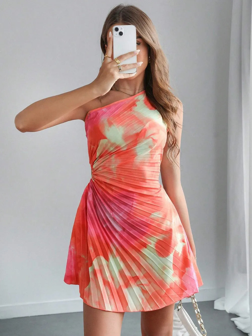Model wearing cutout tie-dye dress styled for a modern resort event