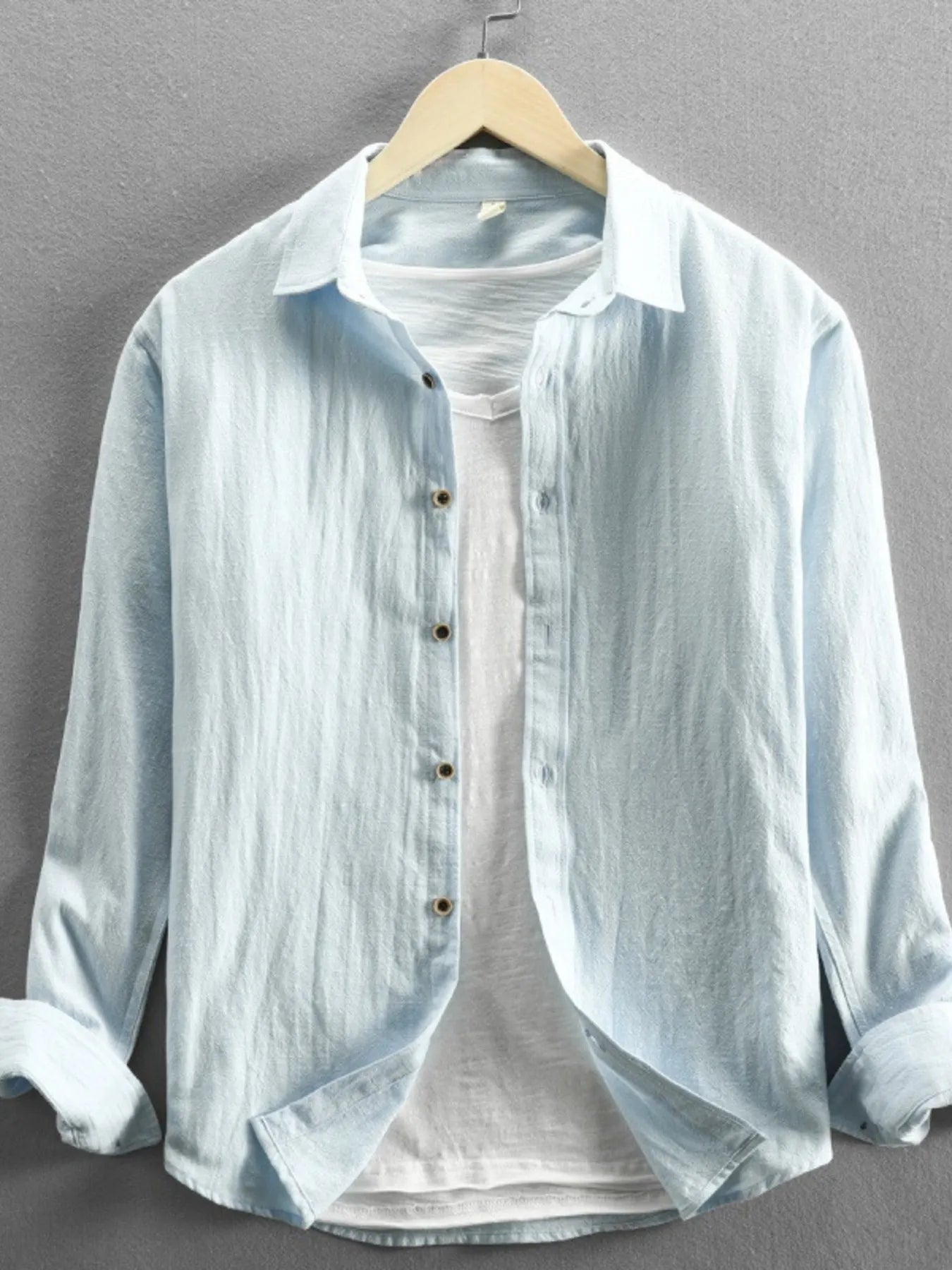 Model wearing plus size button-up long sleeve shirt styled casually